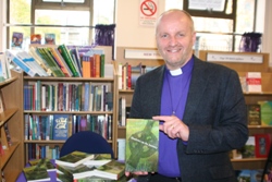 Bishop Alan Abernethy with his book 'Shadows on the Journey,' which forms the topic of his lunchtime lecture on March 6.